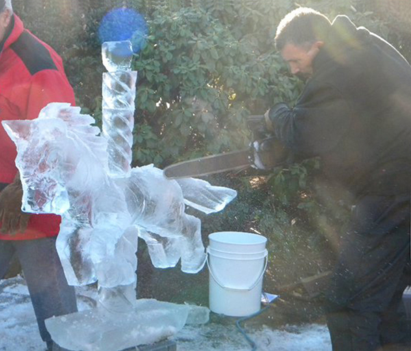 Joe Almeida demonstrating ice sculpture creation with carousel horse