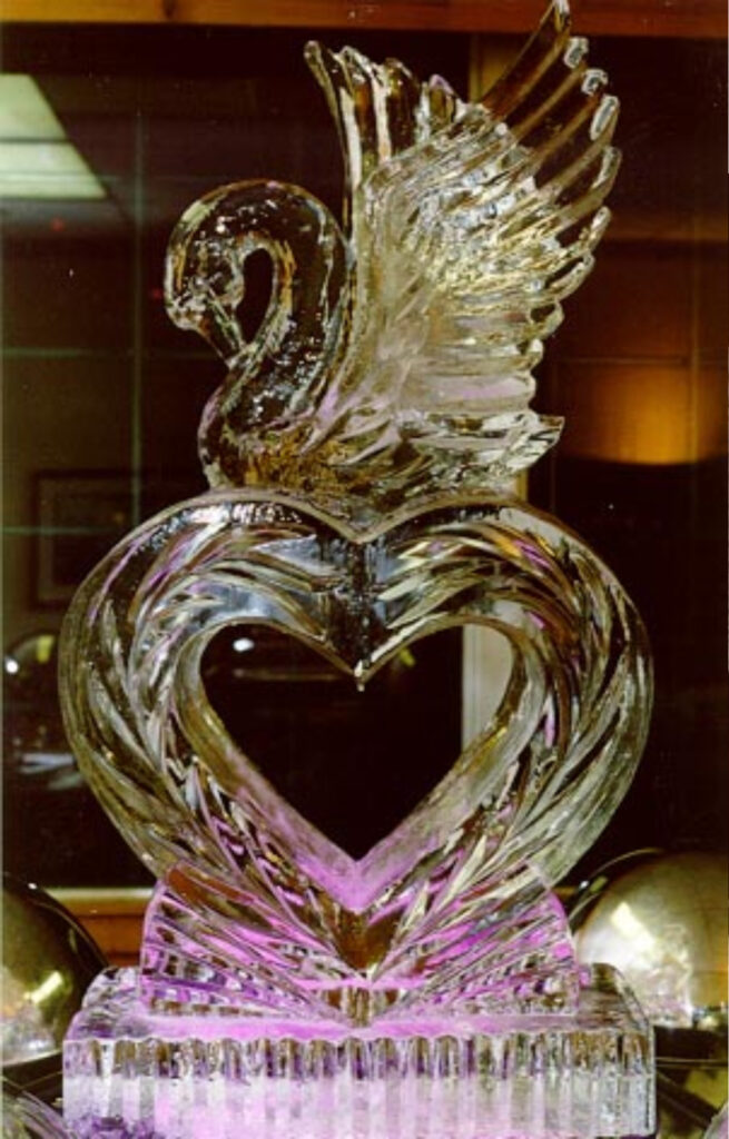 Elegant swan on heart ice sculpture for romantic weddings