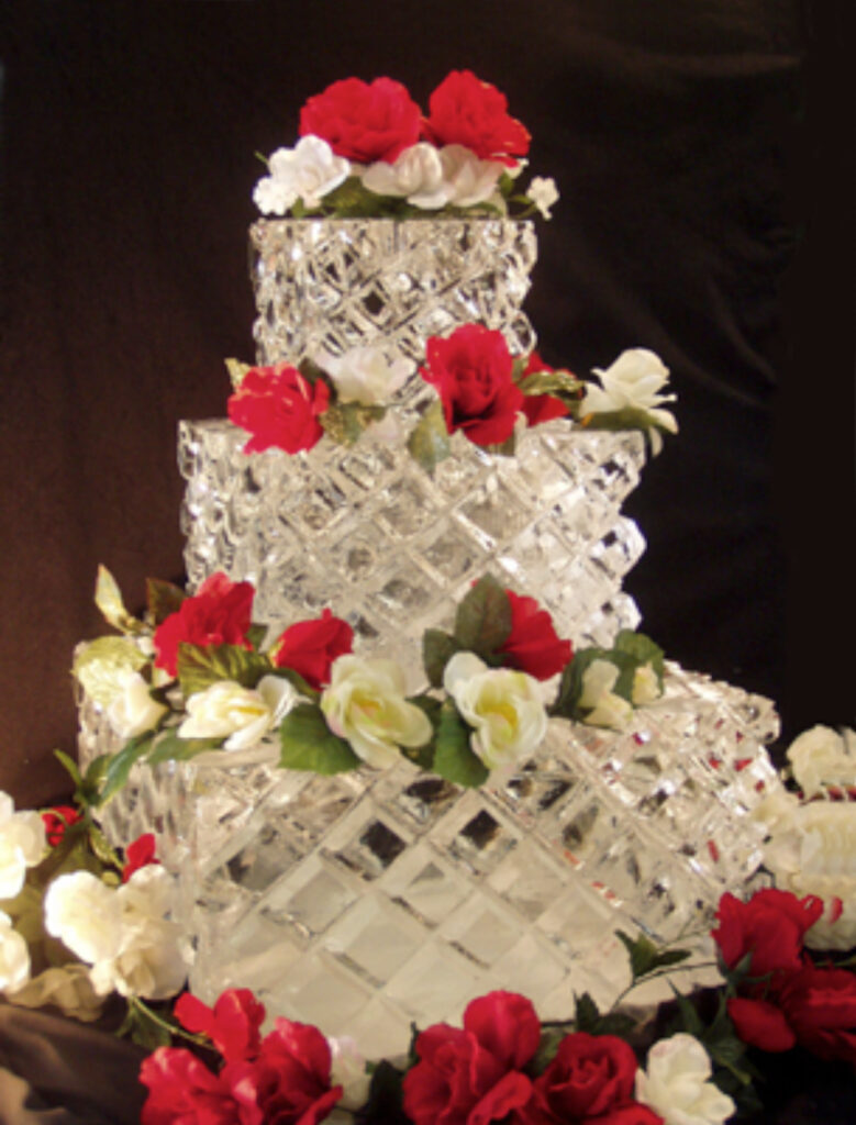 Elegant multi-tier wedding cake ice sculpture with roses